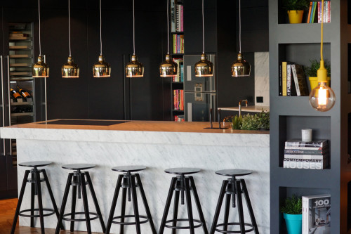 apartment, kitchen, benchtop, hanging lights, gold lighting, dark grey paint, barstools