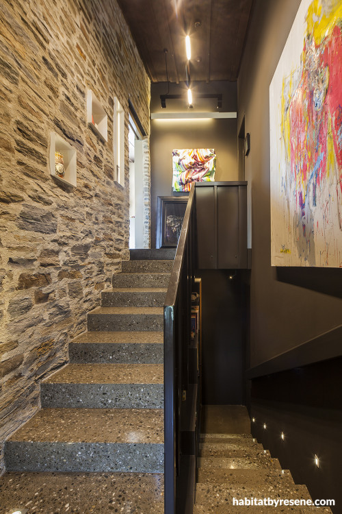 entranceway, stairwell, grey hallway, brown hallway, concrete floor, brick feature wall