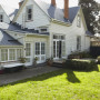 house exterior, green house, green painted weatherboards, neutrals, garden, white house