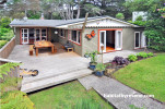 house exterior, painted weatherboards, deck, outdoor living, burnt orange 