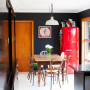 black dining room, open-plan dining, red fridge, black paint 