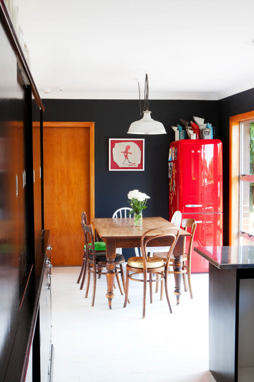 black dining room, open-plan dining, red fridge, black paint