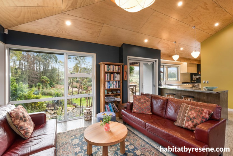 living room, lounge, plywood ceiling, red couch, blue lounge, blue feature wall, yellow feature wall
