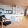 kitchen, white kitchen, wood ceiling, coloured bar stools, timber floors, white living room, resene