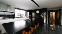 This striking black kitchen is the crown jewel of a contemporary North Otago farmstead photo