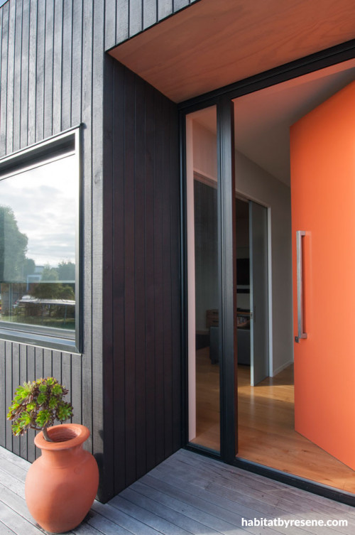 house exterior, black house, orange front door, black exterior, orange and black, black cladding