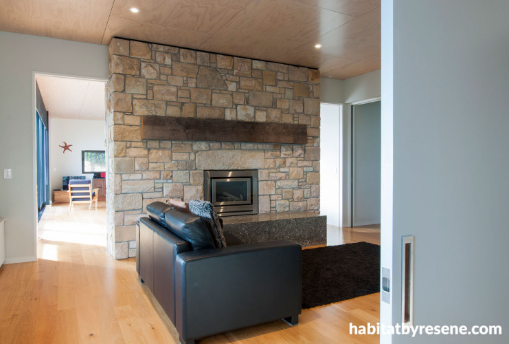 living room, lounge, white lounge, stone feature wall, fireplace, grey door