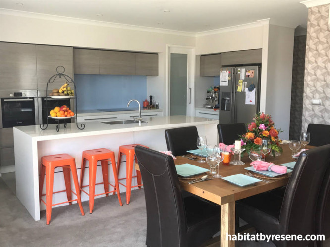 kitchen, dining room, blue splashback, orange chairs, white walls, resene double alabaster