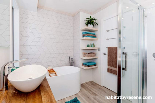 white bathroom, freestanding bath, geometric tiles, open shelving