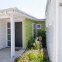 painted weatherboards, white house, green feature wall, green entranceway, house exterior
