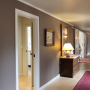 hallway, brown hallway, neutrals, barn style doors, grand, brown paint, brown entranceway