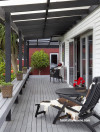 outdoor living, deck, house exterior, white house, white exterior, red exterior, veranda 