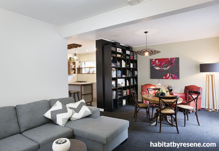 living room, lounge, dining room, black carpet, white paint, green feature wall, upcylcled bookshelf