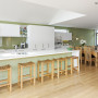 green kitchen, living area, wooden floors, green splashback, lounge, green and white paint
