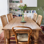 dining room, wooden dining table and chairs, green feature wall, green kitchen