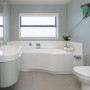 blue bathroom, beach house, white cabinetry, interior