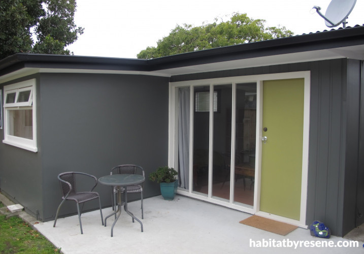 1970s home, house exterior, sleepout, grey exterior, green door, grey sleepout