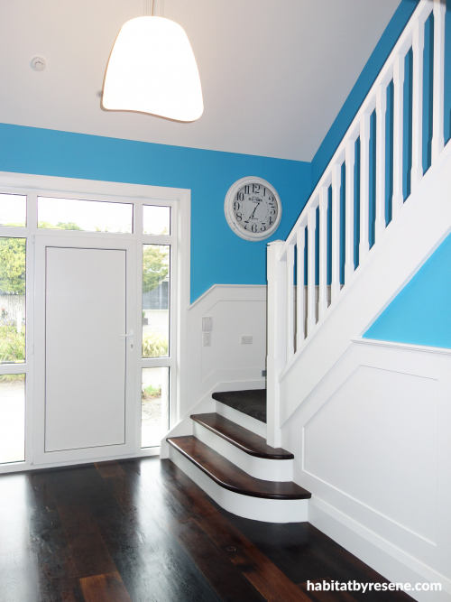 white stairs, white staircase, blue, bright blue, hallway, painted panels, paint ideas, paint trends