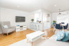white kitchen, white living room, white lounge, white paint, blue furnishings, timber floorboards