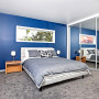 blue bedroom, feature wall, master bedroom, grey and blue, grey carpet, blue paint 