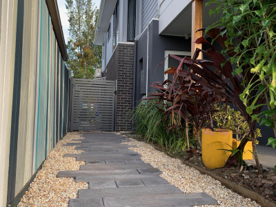 This artist’s Brisbane home is so colourful even the 85m fence is an elegant rainbow