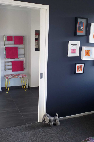 A funeral assistant looks on the bright side of life using bold Resene Scrumptious and Resene Fizz in her home A funeral assistant looks on the bright side of life using bold Resene Scrumptious and Resene Fizz in her home