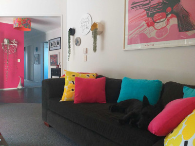 A funeral assistant looks on the bright side of life using bold Resene Scrumptious and Resene Fizz in her home